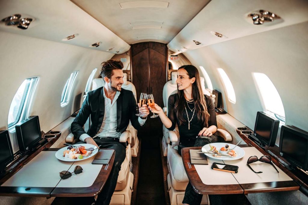 couple enjoying first class in airplane