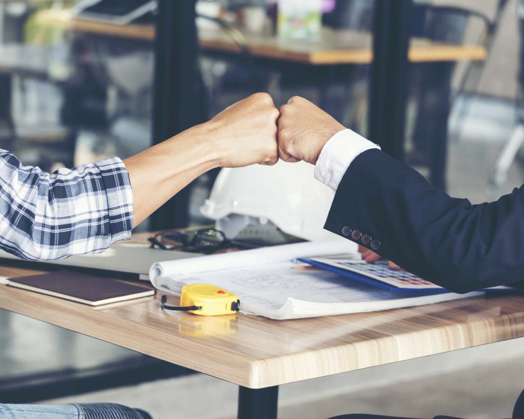 Two men fist bumping